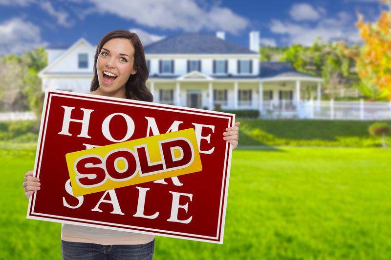 Mixed Race Female with Sold Sign In Front of her Baytown, TX House