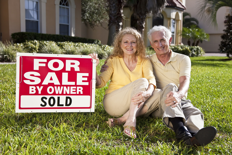 Senior Couple outside Sacramento, CA House with For Sale Sold Sign