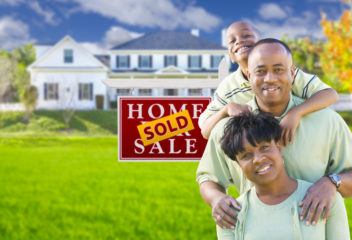 African American Family In Front of Their Maryland House With Sold Sign