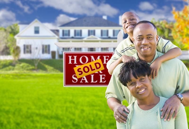 African American Family Looking Happy In Front of Their Maryland House With Sold Sign