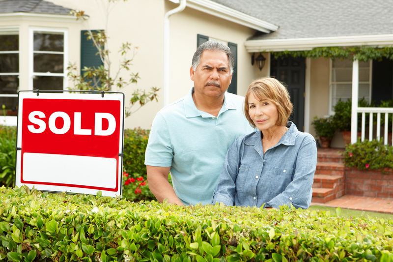 Senior Hispanic couple outside their Illinois house