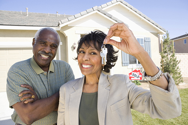 Senior Newport Beach Couple Smiling Outside Home