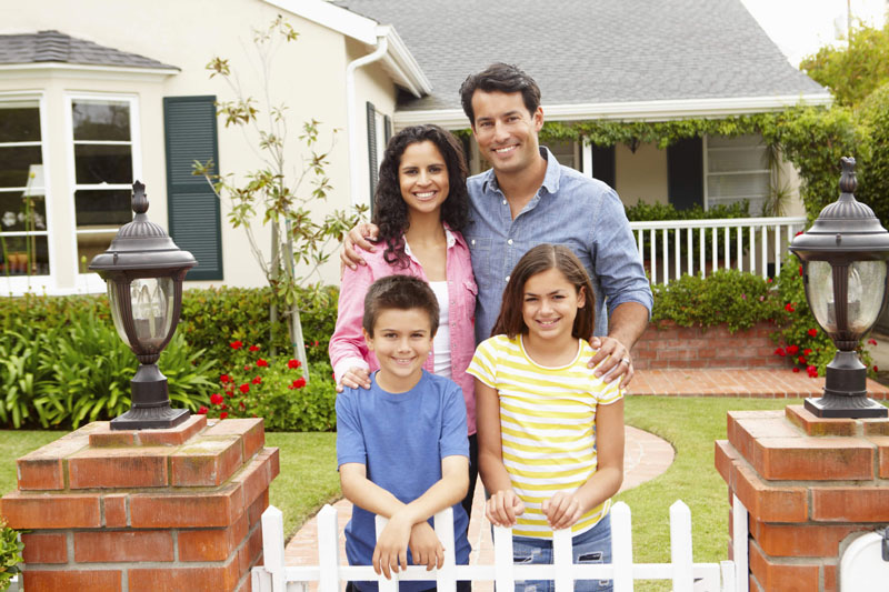 Model family standing outside their home in Charlotte